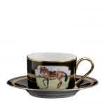 Imperial Horse Cup and Saucer Inspired by 18th century Continental paintings depicting the Noble Horse of Royalty, Julie Wear presents high spirited horses caparisoned in regal trappings, with ornamental saddles and bridles and adorned with tassels; she translates them into a highly sophisticated design that makes a bold statement on any table. Dramatic black ground accented with gold, including hand painted burnished gold cup handles enhances the splendor of the magnificent Imperial Horse.

Please call store for delivery timing.