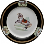 Imperial Horse Dessert Plate Inspired by 18th century Continental paintings depicting the Noble Horse of Royalty, Julie Wear presents high spirited horses caparisoned in regal trappings, with ornamental saddles and bridles and adorned with tassels; she translates them into a highly sophisticated design that makes a bold statement on any table. Dramatic black ground accented with gold, including hand painted burnished gold cup handles enhances the splendor of the magnificent Imperial Horse.

Please call store for delivery timing.