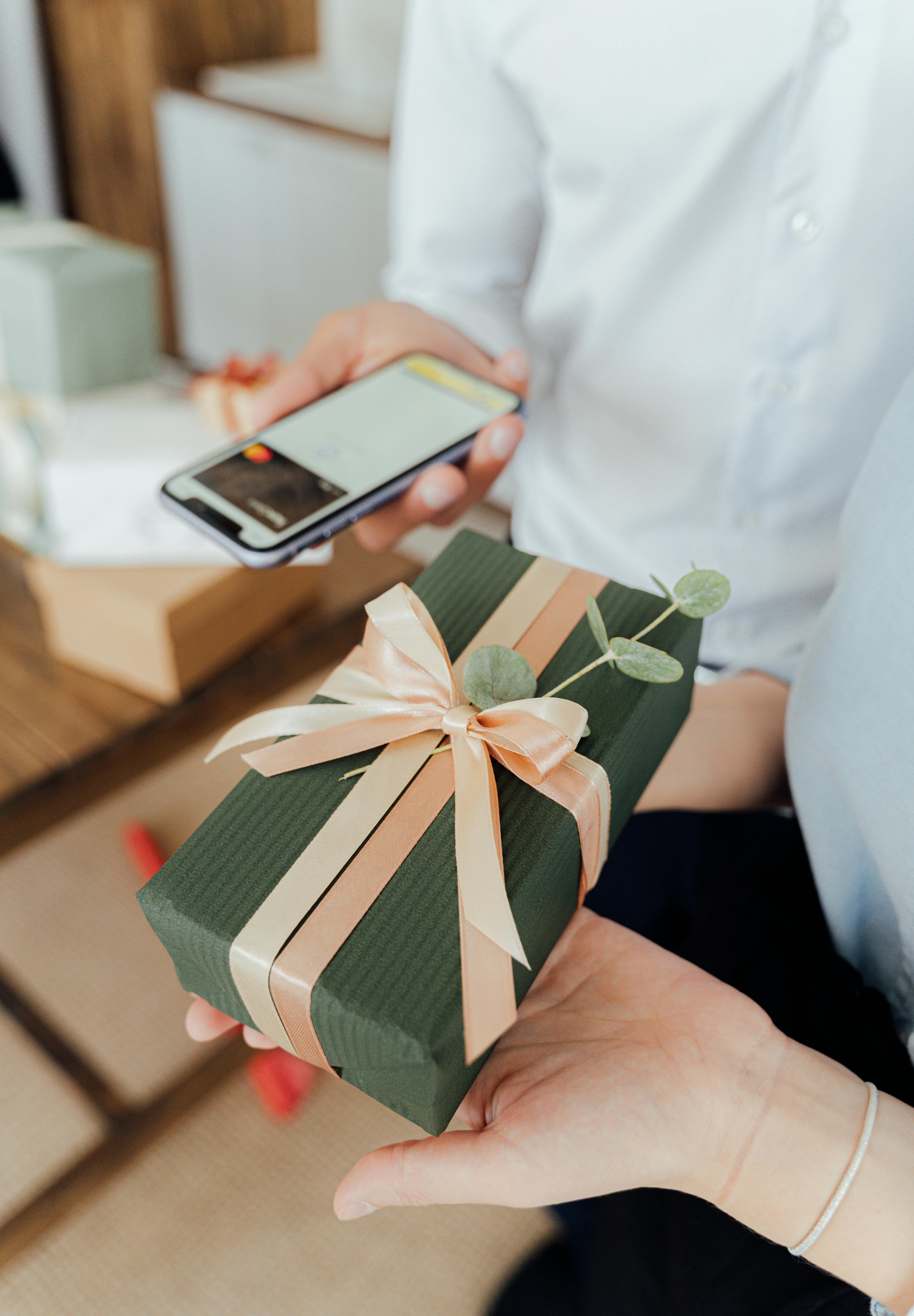 A Family Member Paying For A Beautifully Wrapped Gift Registry Item At L.V.Harkness