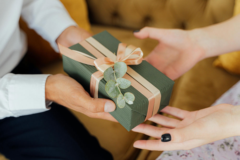 A Family Member Receiving A Beautifully Wrapped Gift Registry Item At L.V.Harkness